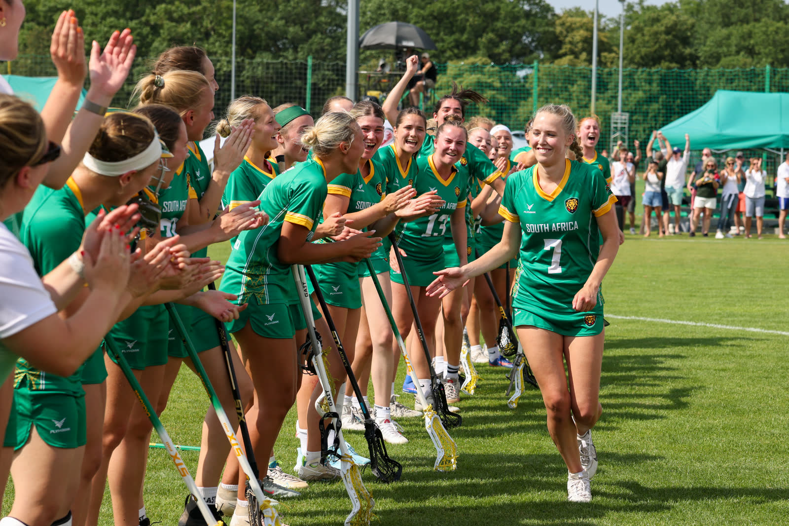 South Africa players running onto the field, high-fiving teammates